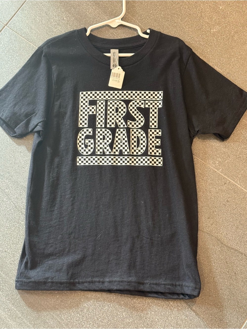 Next Level Apparel Black Tee with White Checkerboard "FIRST GRADE" Graphic